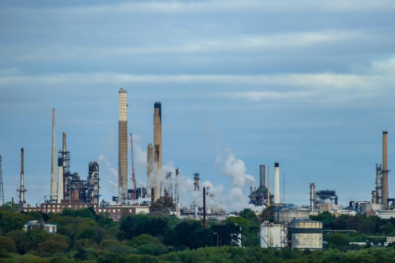 Chennai Petroleum Q2 results: oil refinery towers and storage tanks against a cloudy sky