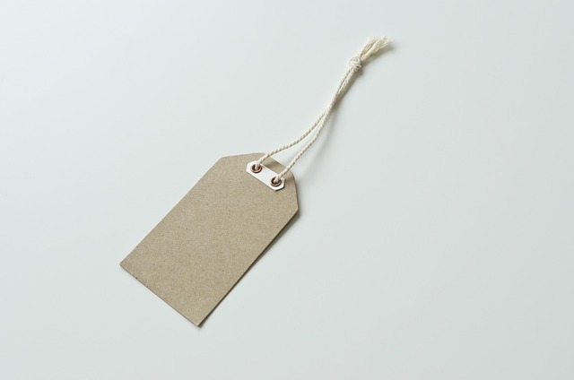 Retail discount in IPO: a blank brown kraft paper price tag with a cotton string on a white surface