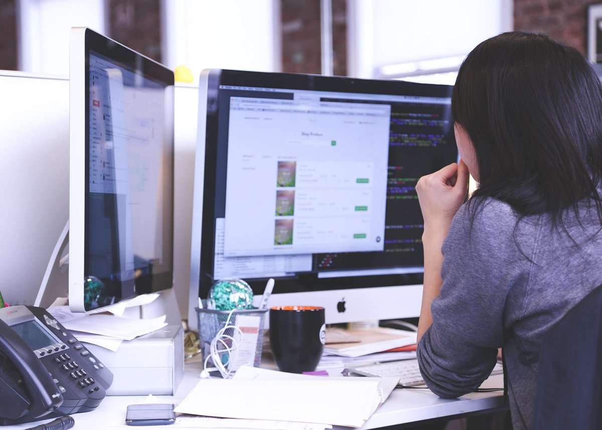 Coforge Q2 results: software engineer working at a desktop computer in an IT office