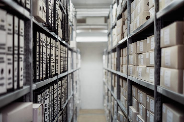 Cash conversion cycle: rows of stored boxes on metal warehouse shelves