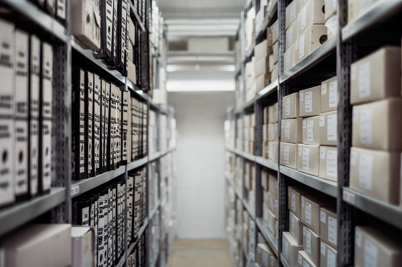 Cash conversion cycle: rows of stored boxes on metal warehouse shelves