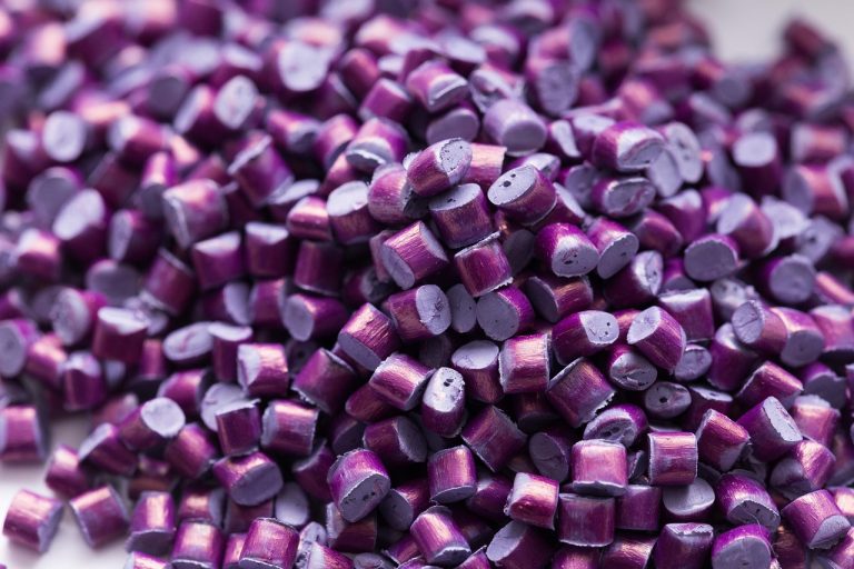 Supreme Petrochem Q2 results: close-up of purple plastic polymer granules