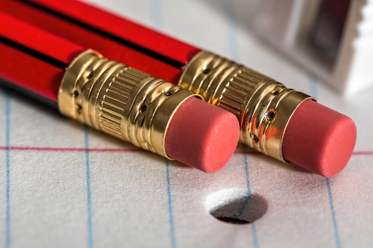 IPO bid modification concept: pencil erasers on lined paper, ready to correct an application