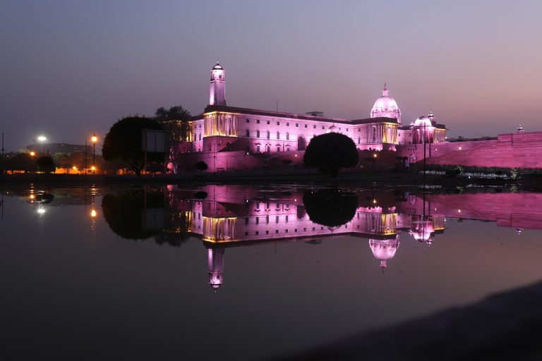 Bharat 22 ETF theme: government secretariat building in New Delhi lit up at dusk and reflected in water