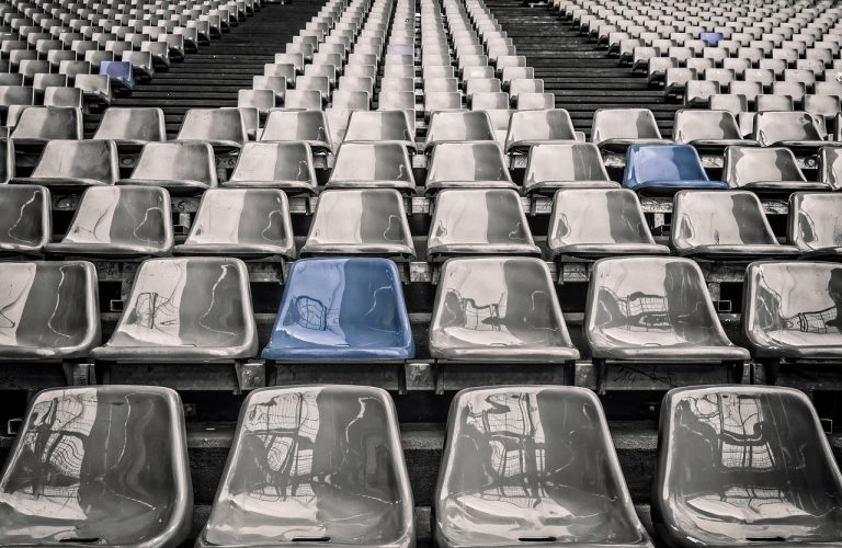 Minimum subscription in IPO: rows of mostly empty grey stadium seats with a few blue seats