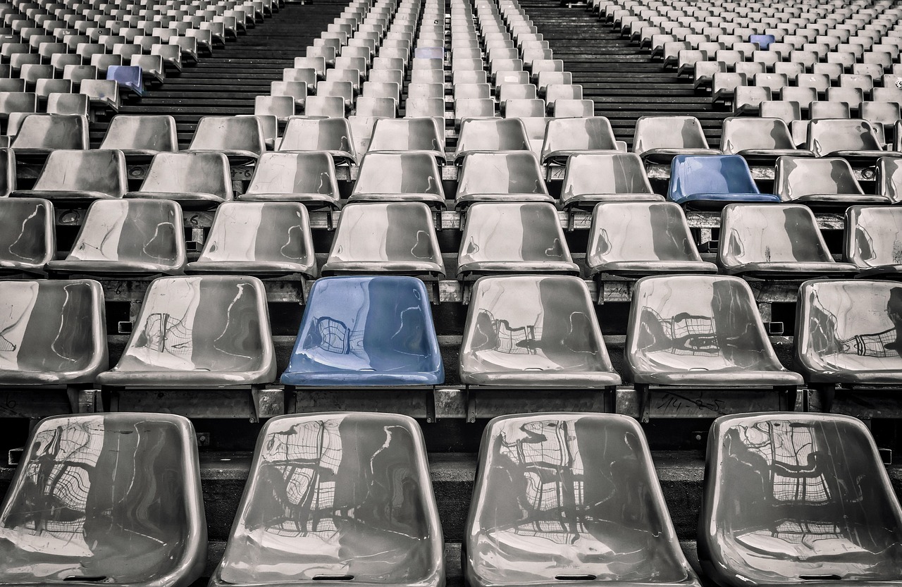 Minimum subscription in IPO: rows of mostly empty grey stadium seats with a few blue seats