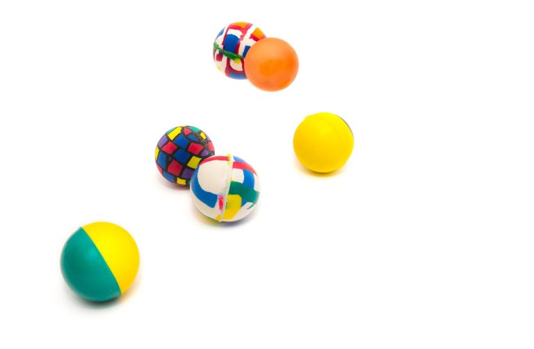 Dead cat bounce: colourful rubber balls bouncing on a white background