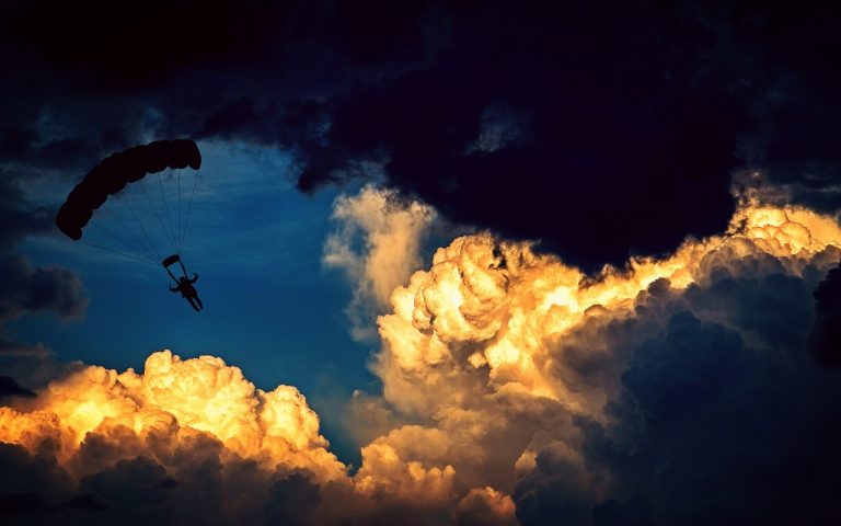 Put ratio backspread: a parachutist descending through dramatic evening clouds