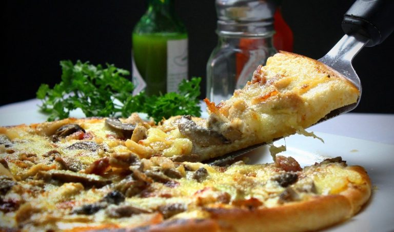 ESOP dilution concept: a slice of pizza being lifted from a pie, showing each owner's share getting smaller