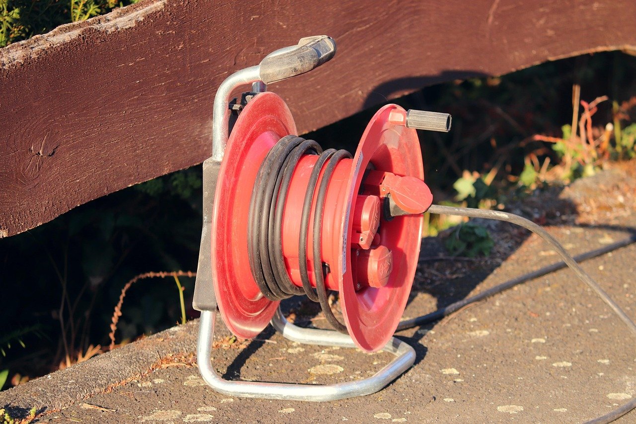 KEI Industries Q2 results: a red reel of electrical cable on a wooden bench