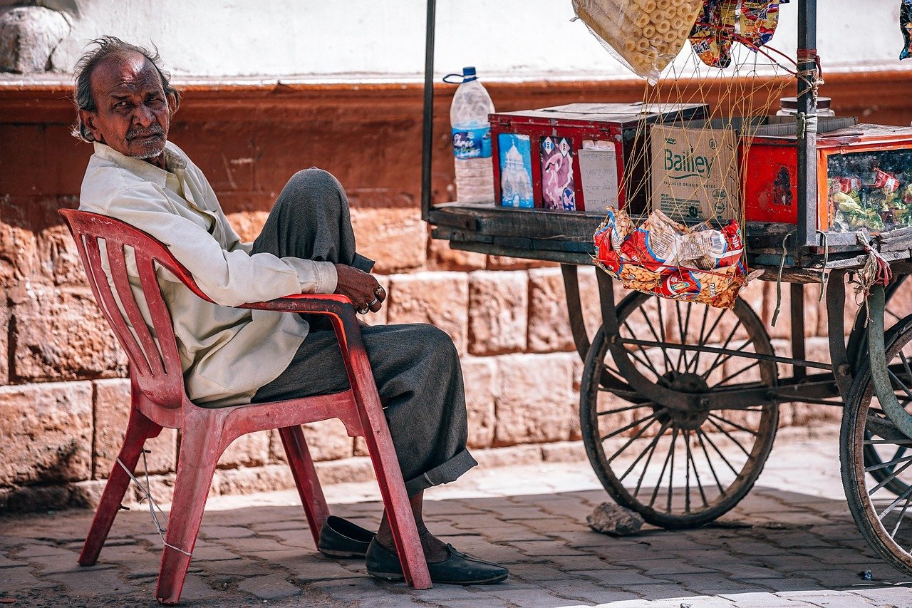 Aye Finance Q2 results: a micro-enterprise street vendor sitting beside his cart in India