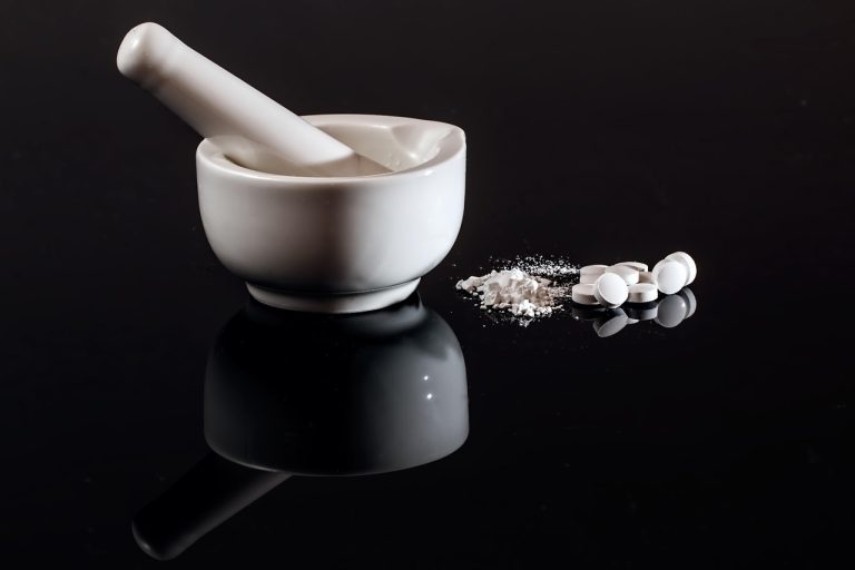 Zydus USFDA approval: white mortar and pestle with tablets and powdered medicine