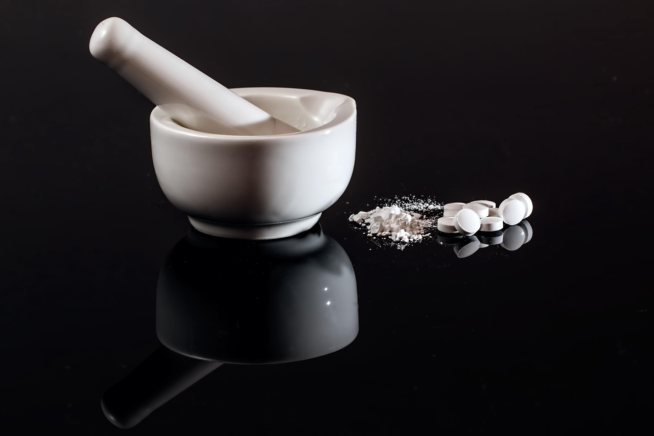 Zydus USFDA approval: white mortar and pestle with tablets and powdered medicine