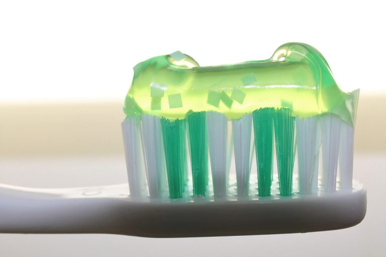 Colgate Q2 results: green gel toothpaste on a white toothbrush