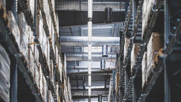 IndiaMART Q2 results: tall warehouse racks stacked with packed goods