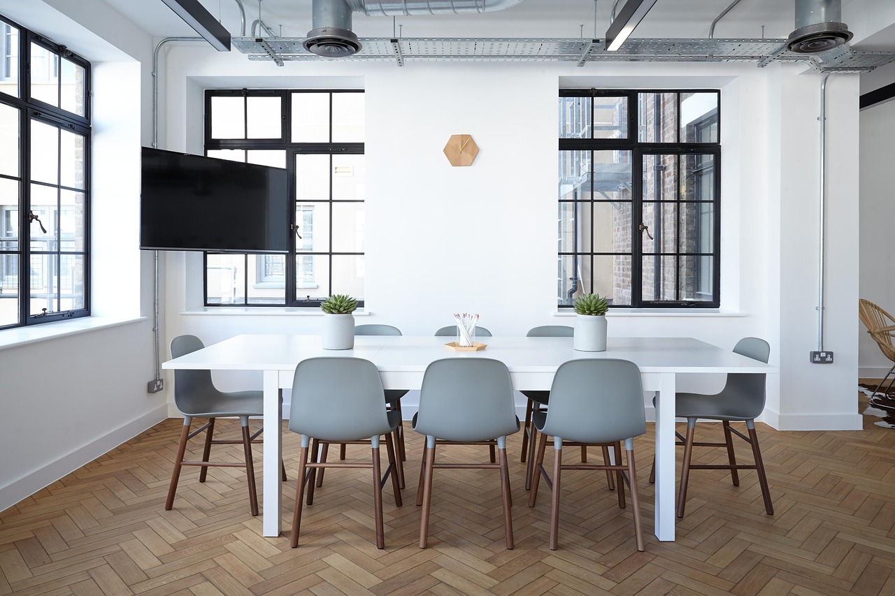 Insider trading rules SEBI: an empty company boardroom with a long white table and grey chairs