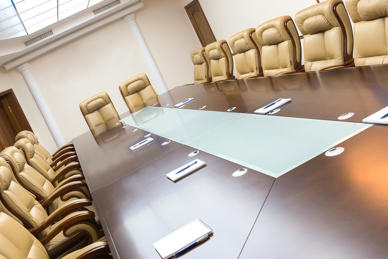 Interim dividend vs final dividend: empty company board room where directors meet to declare dividends