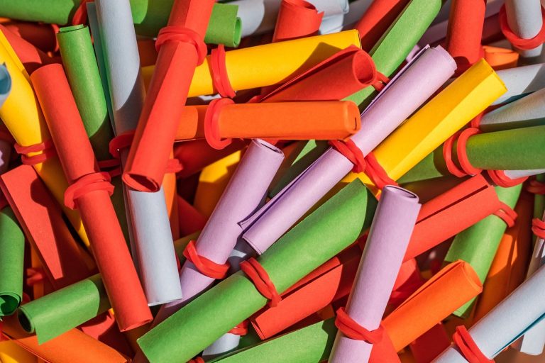 IPO basis of allotment concept: heap of rolled-up coloured lottery slips ready for a draw