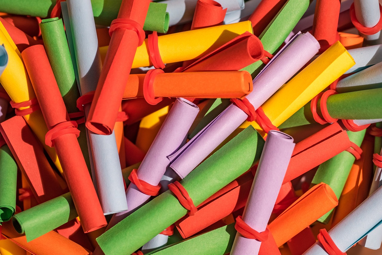 IPO basis of allotment concept: heap of rolled-up coloured lottery slips ready for a draw