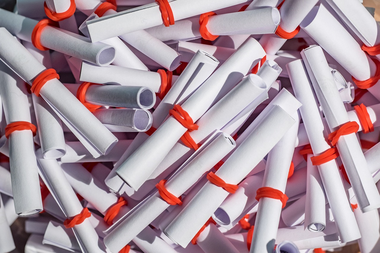 IPO oversubscription meaning concept: a heap of rolled white paper slips tied with red bands, like tickets in an allotment draw