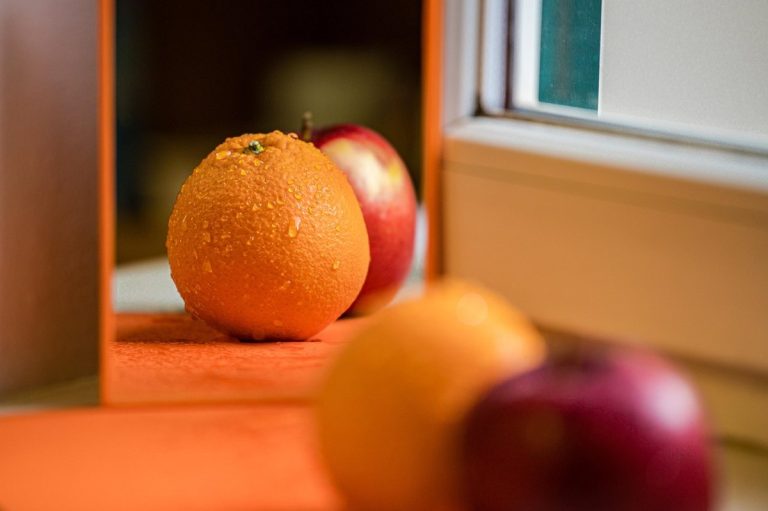 IPO valuation peer comparison: an orange and an apple side by side on a windowsill