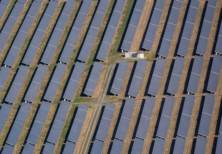 IREDA Q2 results: aerial view of rows of solar panels on a solar farm