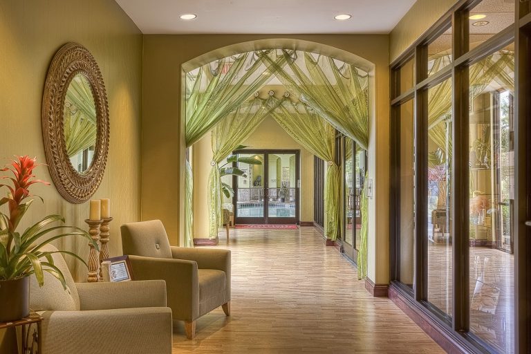 ITC Hotels Q2 results: a quiet hotel corridor with armchairs and glass doors