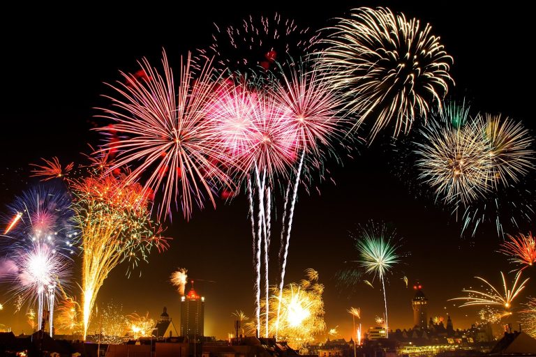 January effect: New Year's Eve fireworks bursting over a city skyline at night, marking the turn of the calendar year