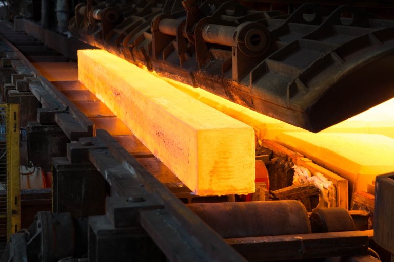 Jayaswal Neco Q2 results: a glowing hot steel bloom moving along the rollers of a rolling mill