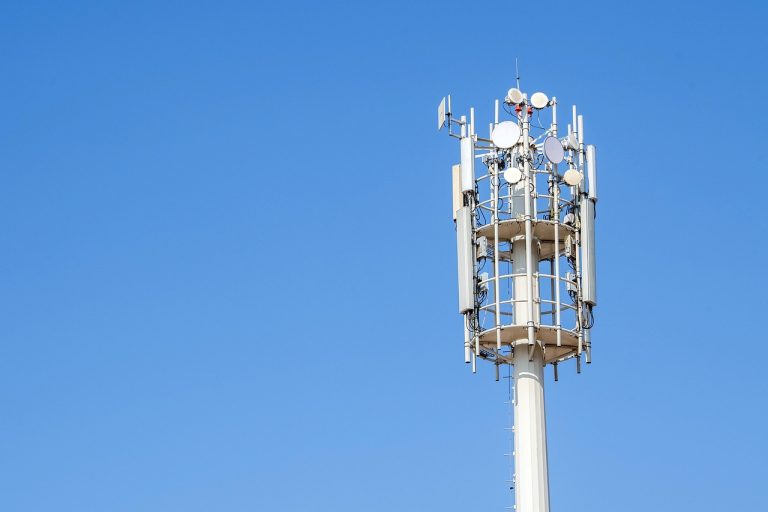 Jio Platforms listing: mobile telecom tower with antennas against a clear blue sky