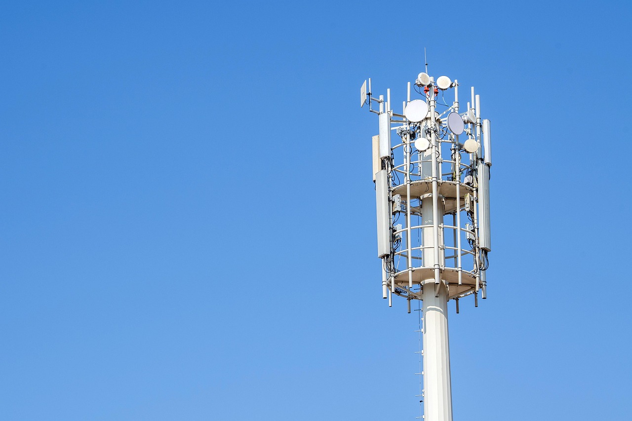 Jio Platforms listing: mobile telecom tower with antennas against a clear blue sky