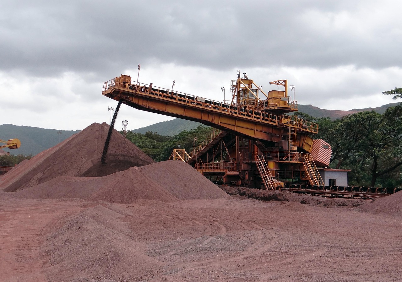 JSW Steel Orissa High Court relief: iron ore being stacked by a conveyor at an Indian opencast mine
