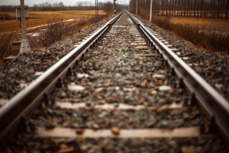 Keltner channel indicator concept: two parallel railway tracks running into the distance like upper and lower bands