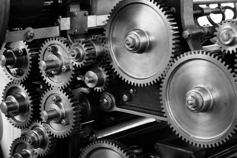Know sure thing indicator: interlocking metal gears of different sizes turning together