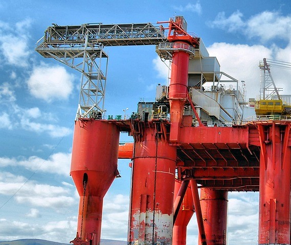 L&T Q2 results: red offshore drilling platform with cranes against a blue sky