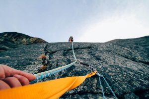 Maximum adverse excursion and stop-loss: climber's safety rope clipped to a rock face