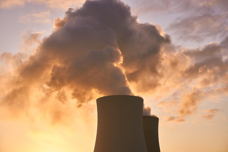 NTPC nuclear feasibility studies: cooling towers releasing steam against a sunrise sky