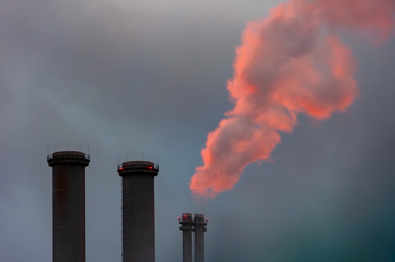 NTPC buyback report: power plant chimneys with a plume of steam at dusk