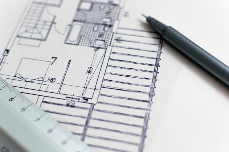 Objects of the issue in an IPO: architectural floor plan with a pen and ruler, a project being planned