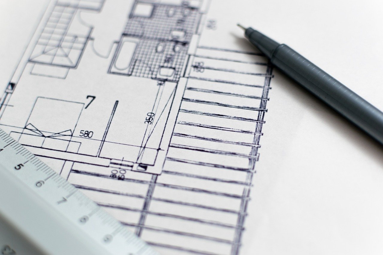 Objects of the issue in an IPO: architectural floor plan with a pen and ruler, a project being planned