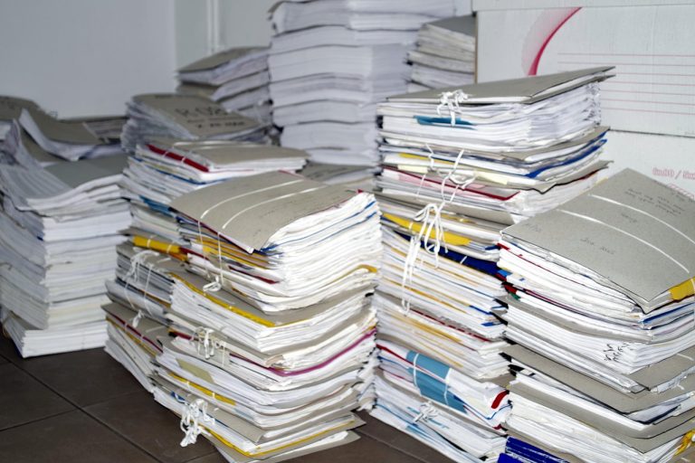 Odd lot trading NSE concept: tied stacks of old paper files and folders, like the physical share paperwork the odd lot window once served