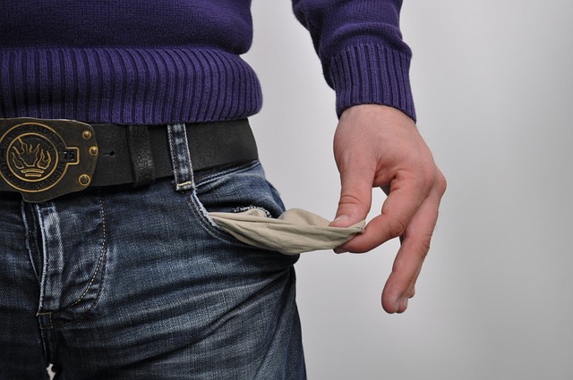 Ohlson O-score bankruptcy risk: a man pulling out an empty trouser pocket