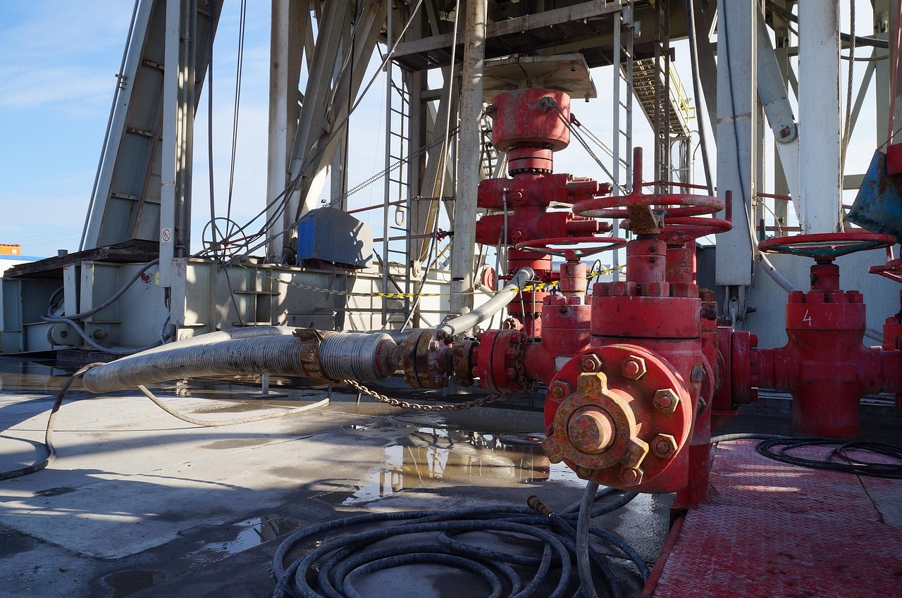 Oil India CBM block: red wellhead valves on the floor of an onshore drilling rig