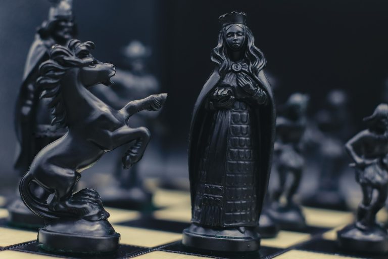 Open offer in share market: black chess pieces facing off on a board, a takeover in progress