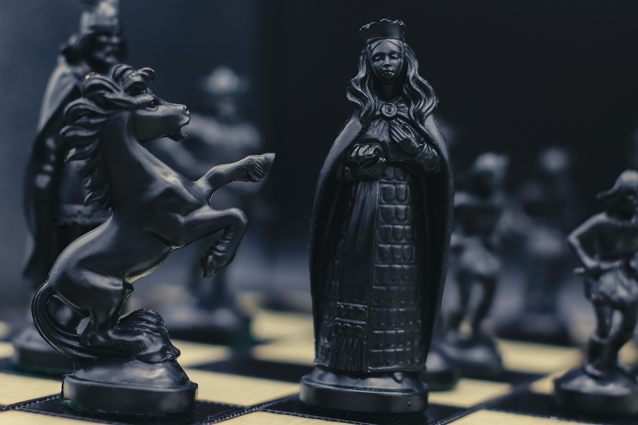Open offer in share market: black chess pieces facing off on a board, a takeover in progress