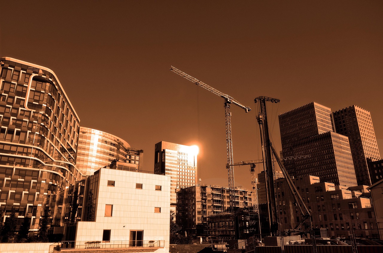 B L Kashyap order: high-rise buildings under construction with tower cranes against the sky