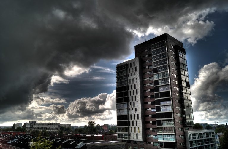 Smallcap 250 weekly fall: dark storm clouds gathering over city tower blocks