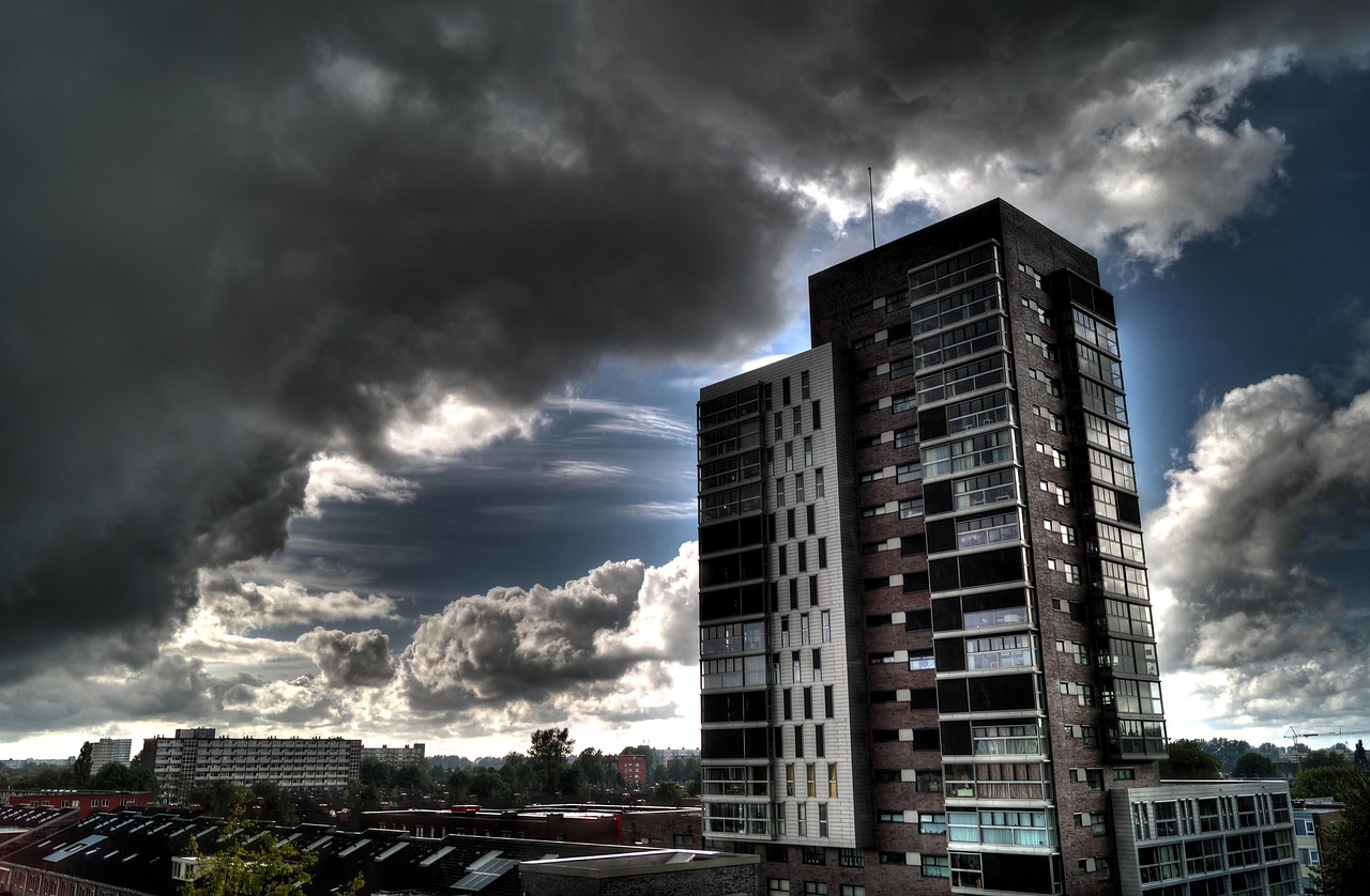 Smallcap 250 weekly fall: dark storm clouds gathering over city tower blocks