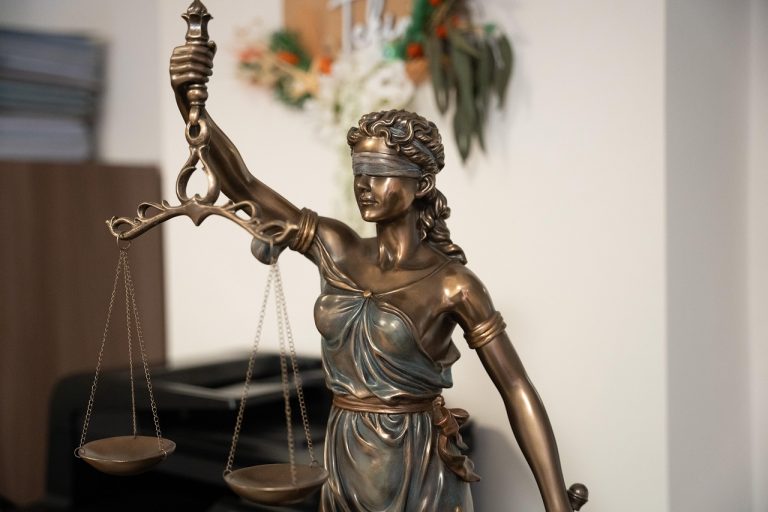 Avadhut Sathe SEBI order: bronze Lady Justice statue holding the scales of justice