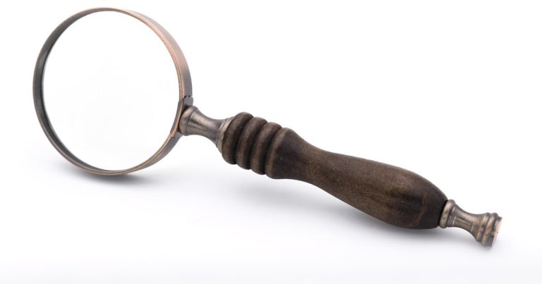 Pe ratio explained - magnifying glass documents